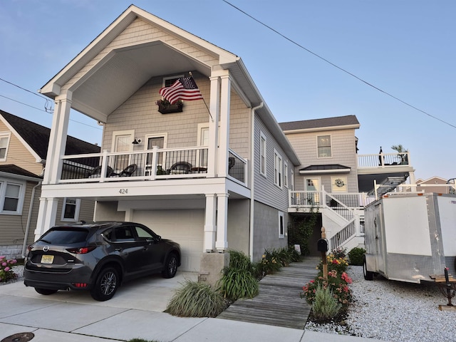 424 W Andrews Ave, Wildwood, NJ 08260 - view of front of property featuring a balcony, an attached garage, concrete driveway, and stairway
