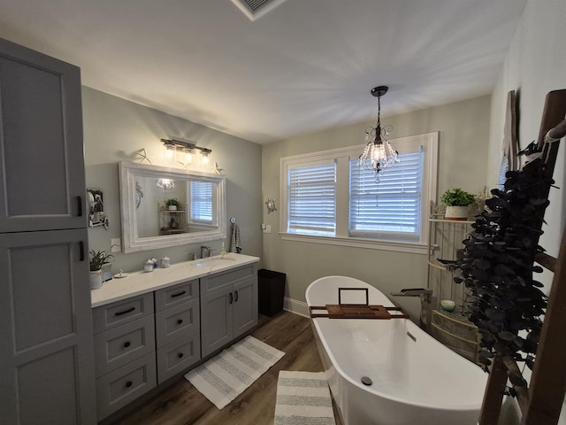 424 W Andrews Ave, Wildwood, NJ 08260 - bathroom with vanity, wood finished floors, a freestanding tub, and a chandelier