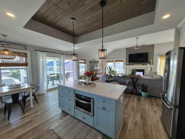 424 W Andrews Ave, Wildwood, NJ 08260 - kitchen featuring stainless steel appliances, a raised ceiling, ceiling fan, a large fireplace, and healthy amount of natural light