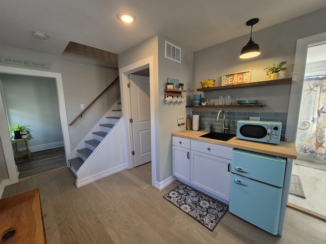 424 W Andrews Ave, Wildwood, NJ 08260 - kitchen featuring wood counters, light wood-style floors, decorative backsplash, open shelves, and recessed lighting