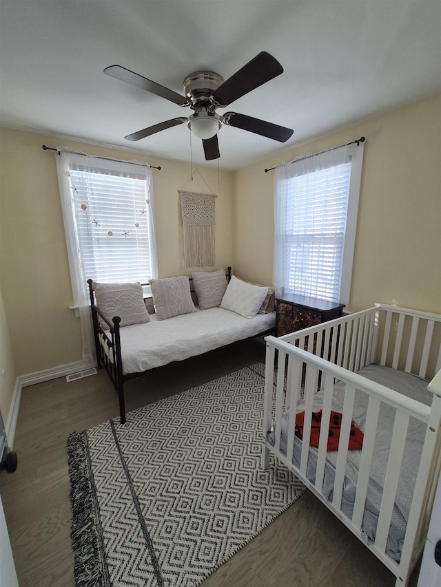 424 W Andrews Ave, Wildwood, NJ 08260 - bedroom with multiple windows, wood finished floors, and a ceiling fan