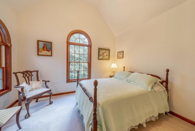 bedroom featuring light colored carpet and vaulted ceiling