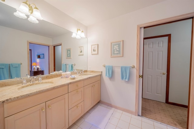 bathroom with vanity, an inviting chandelier, and tile patterned floors