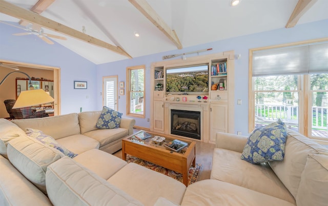 living room featuring vaulted ceiling with beams, ceiling fan, wood-type flooring, and plenty of natural light