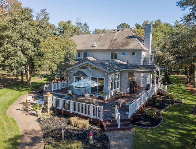 rear view of house with an outdoor hangout area, a patio area, a yard, and a wooden deck