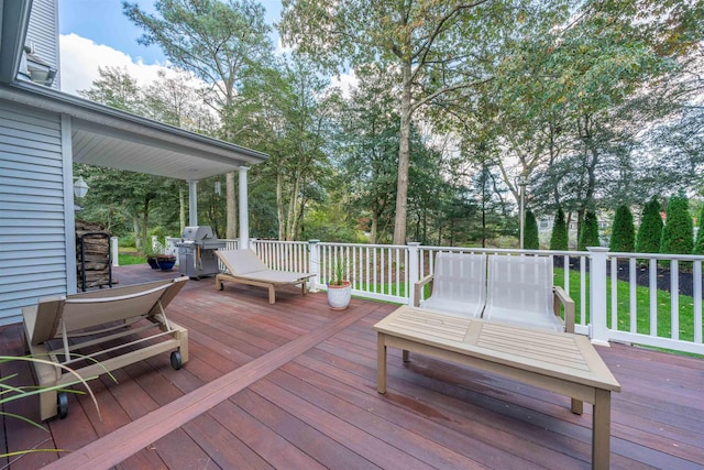 wooden terrace featuring a grill