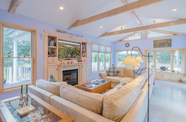 living room with light hardwood / wood-style flooring and lofted ceiling with beams