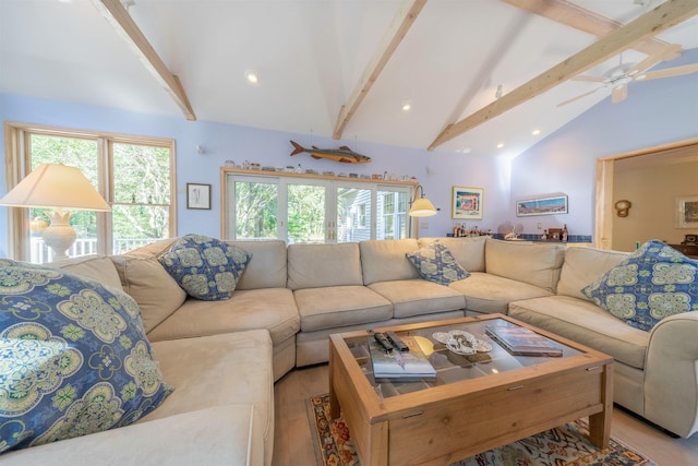 living room with beam ceiling, light wood-type flooring, high vaulted ceiling, and ceiling fan