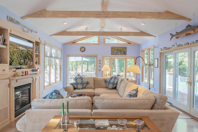 living room featuring light wood-type flooring, french doors, lofted ceiling with beams, and plenty of natural light