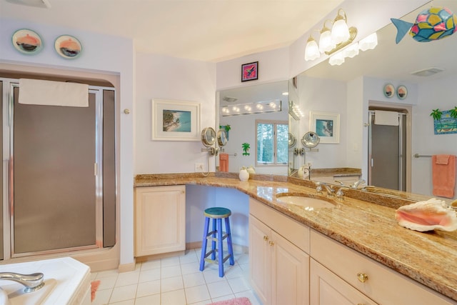 bathroom featuring tile patterned flooring, vanity, and shower with separate bathtub