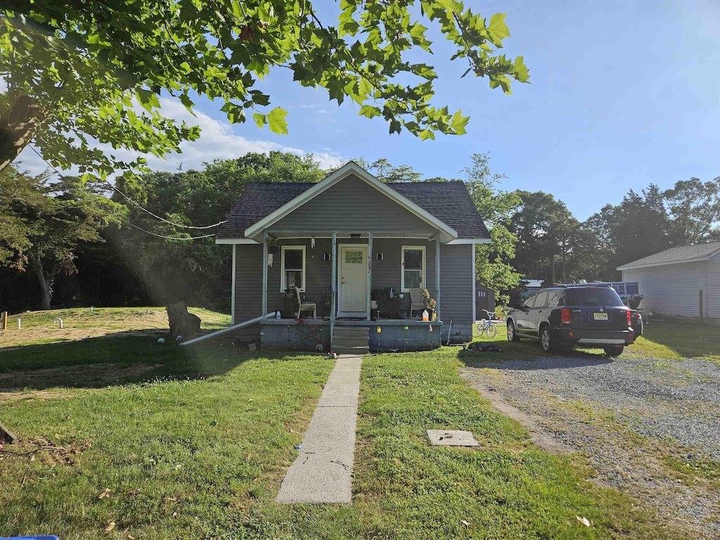 bungalow-style house featuring a porch and a front lawn