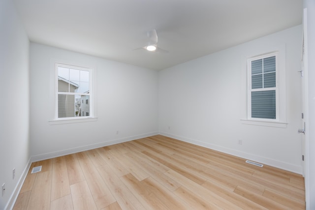 unfurnished room with light wood-type flooring, visible vents, and a ceiling fan