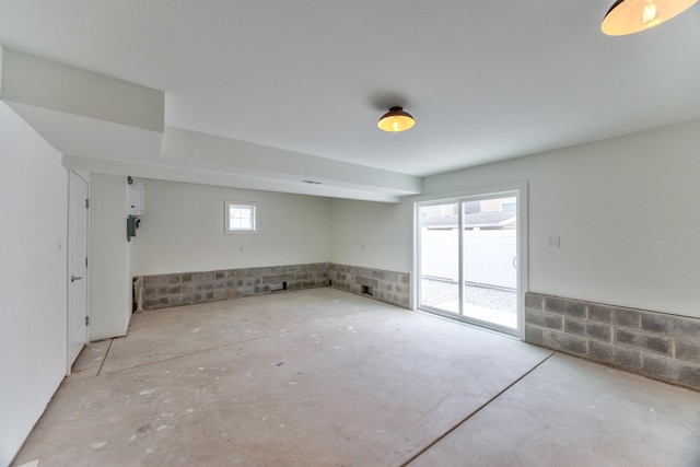 unfurnished room with concrete flooring