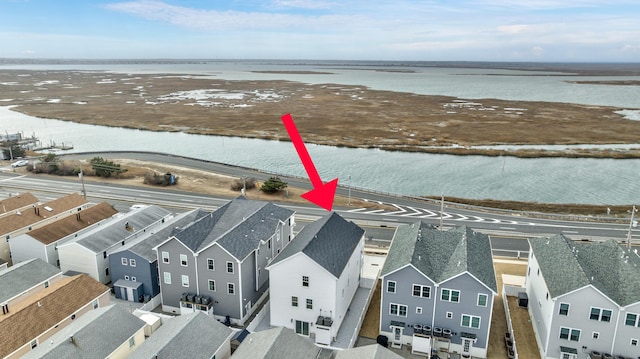 drone / aerial view featuring a residential view and a water view