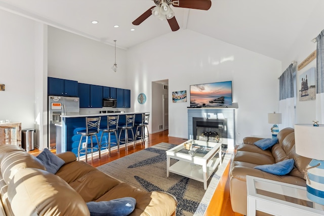 living room with high vaulted ceiling, dark hardwood / wood-style flooring, and ceiling fan