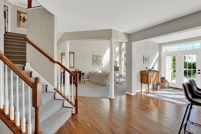 entryway featuring wood-type flooring and ornate columns