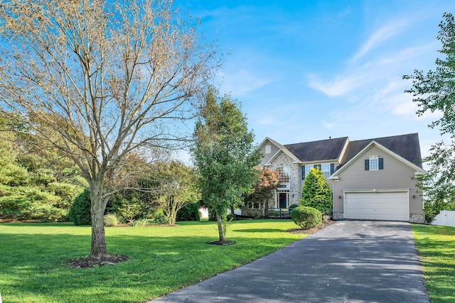 view of front of property with a front yard and a garage