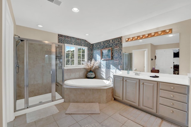 bathroom with tile patterned flooring, vanity, and shower with separate bathtub