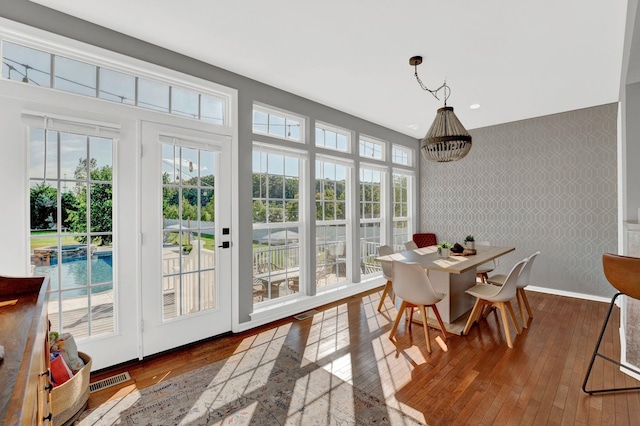 dining room featuring dark hardwood / wood-style flooring and a notable chandelier