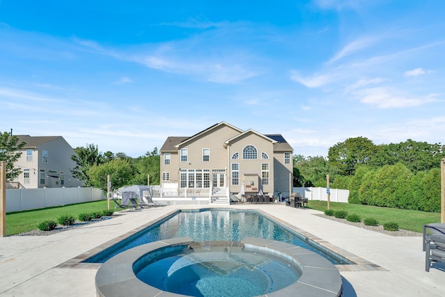 view of pool with a lawn, a patio area, and an in ground hot tub