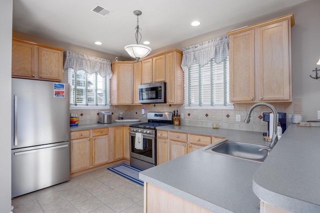 kitchen featuring light brown cabinets and appliances with stainless steel finishes