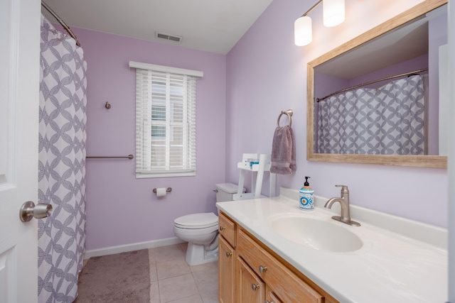 bathroom featuring tile patterned flooring, toilet, vanity, visible vents, and baseboards