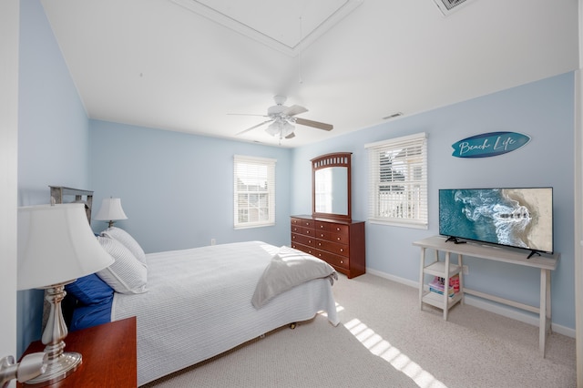 carpeted bedroom featuring visible vents, ceiling fan, attic access, and baseboards