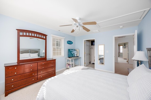 bedroom featuring ceiling fan, baseboards, attic access, and light colored carpet