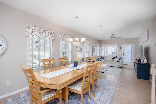 dining room with ceiling fan with notable chandelier, visible vents, baseboards, and light tile patterned floors