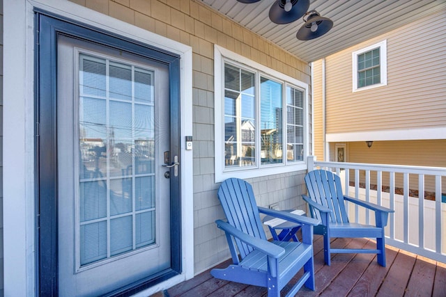 doorway to property featuring ceiling fan and a porch