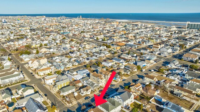 birds eye view of property with a water view and a residential view