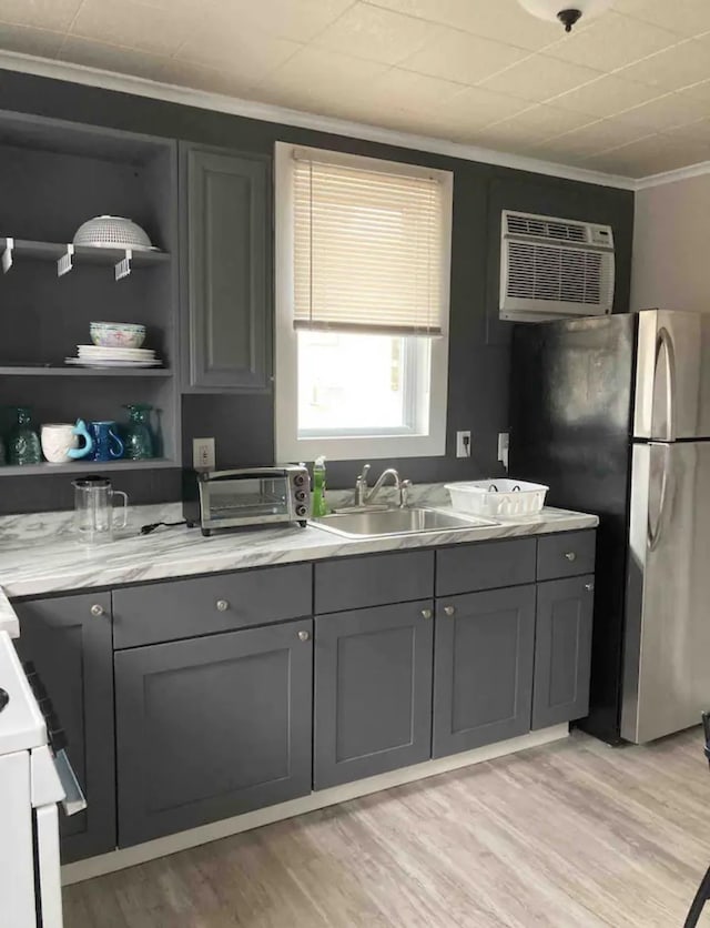 217 Ridgewood Ave, Villas, NJ 08251 - kitchen featuring gray cabinets, crown molding, an AC wall unit, light wood finished floors, and freestanding refrigerator