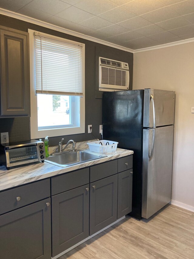 217 Ridgewood Ave, Villas, NJ 08251 - kitchen featuring gray cabinets, a wall mounted air conditioner, ornamental molding, light wood finished floors, and freestanding refrigerator
