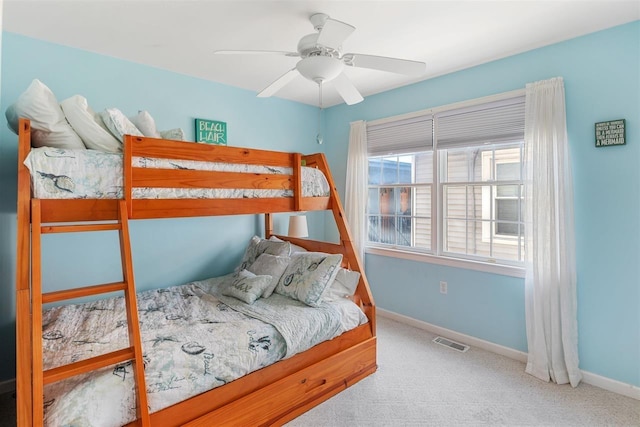 bedroom featuring light colored carpet and ceiling fan