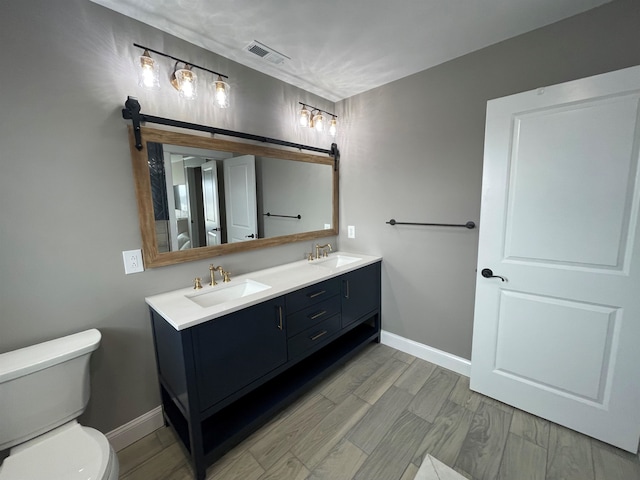 bathroom featuring hardwood / wood-style floors, vanity, and toilet