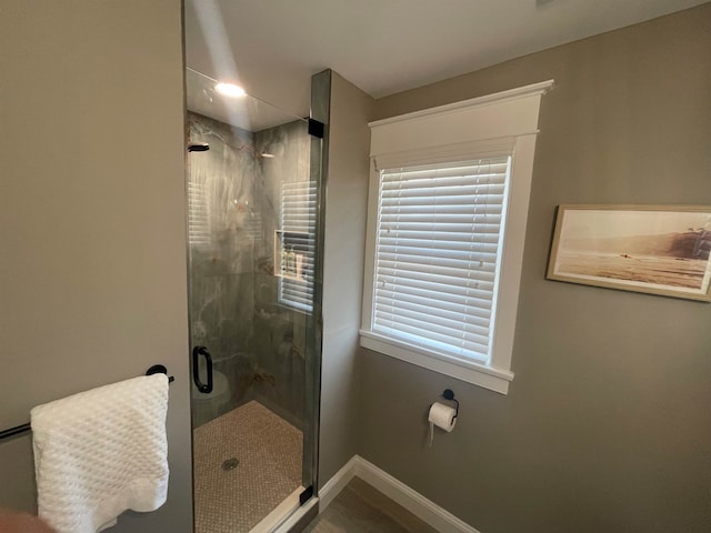 bathroom with a shower with shower door