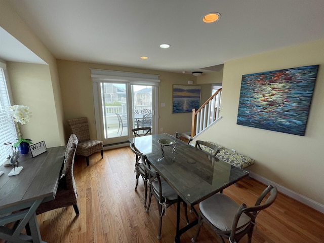 dining room featuring light wood-type flooring and a baseboard heating unit