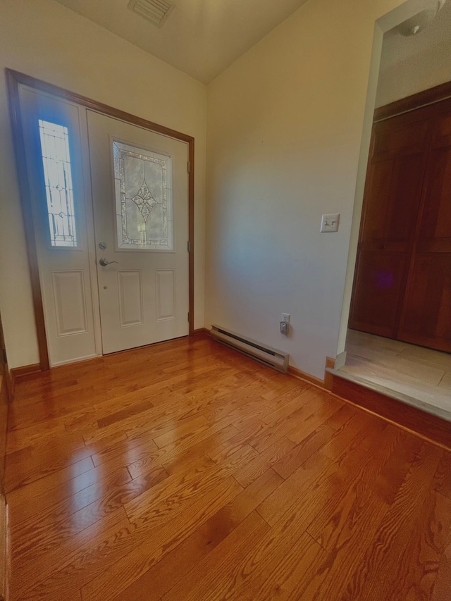 foyer featuring light hardwood / wood-style flooring and a baseboard heating unit