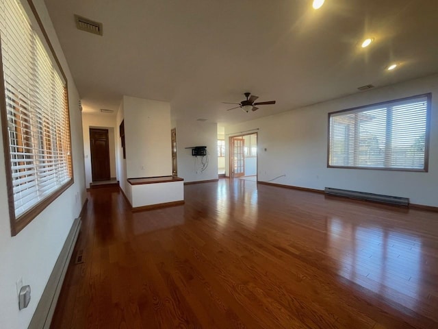 unfurnished living room featuring dark hardwood / wood-style floors, ceiling fan, and a baseboard heating unit