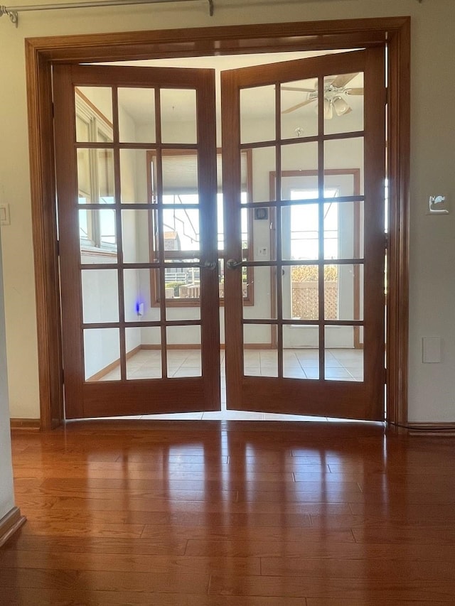 doorway featuring hardwood / wood-style flooring, ceiling fan, and french doors