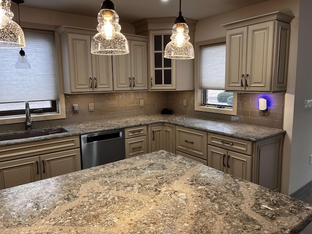 kitchen with decorative backsplash, dishwasher, dark stone counters, and sink