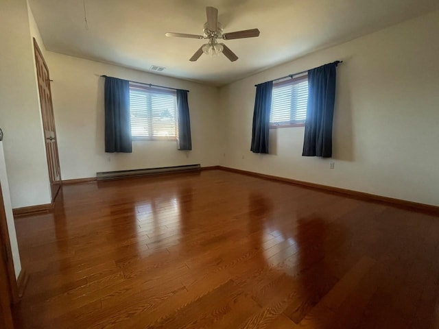 unfurnished room with hardwood / wood-style floors, plenty of natural light, baseboard heating, and ceiling fan