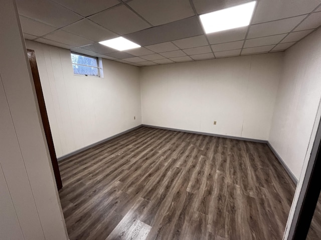 unfurnished room featuring a paneled ceiling and dark wood-type flooring