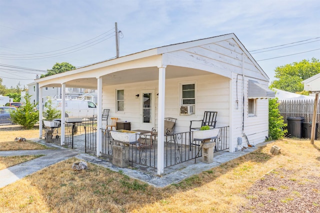 rear view of house featuring fence