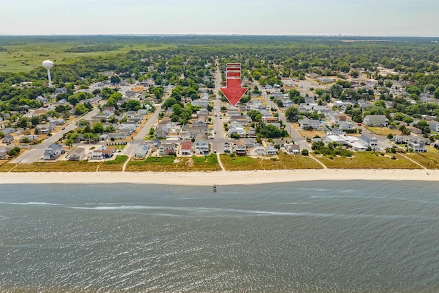 bird's eye view featuring a water view and a beach view