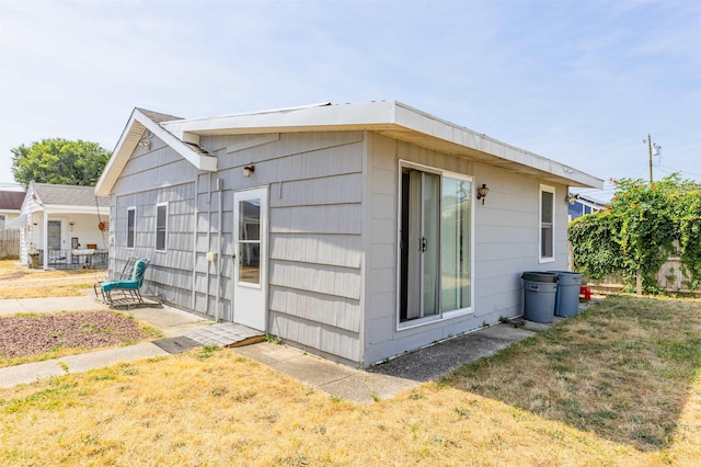 view of side of home featuring a lawn