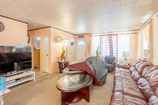 carpeted living area with crown molding