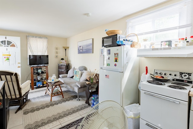 kitchen featuring white appliances, under cabinet range hood, light tile patterned floors, and open floor plan