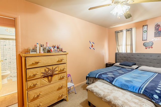 bedroom with ceiling fan, carpet floors, ensuite bath, and baseboards