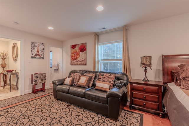 living room featuring baseboards, visible vents, and recessed lighting